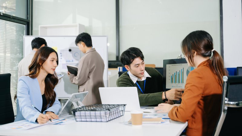 Business leaders collaborating to review financial reports and plan an enterprise analytics implementation.