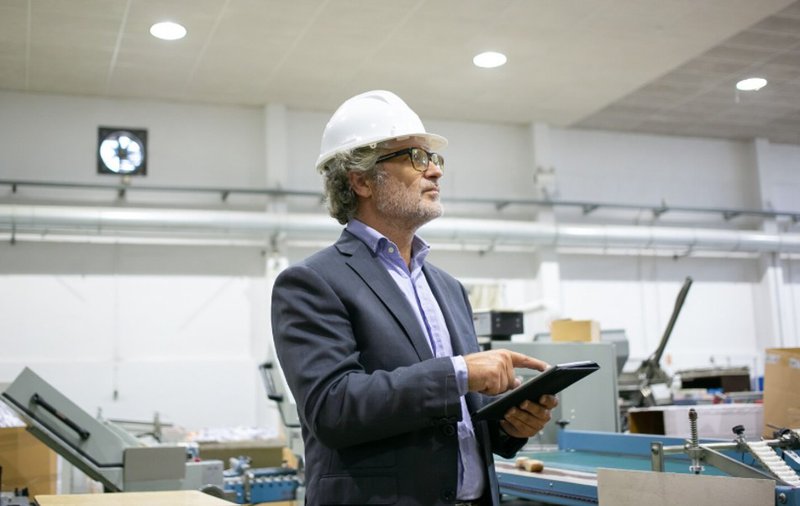 a man holding a tablet scanning the area. field operations