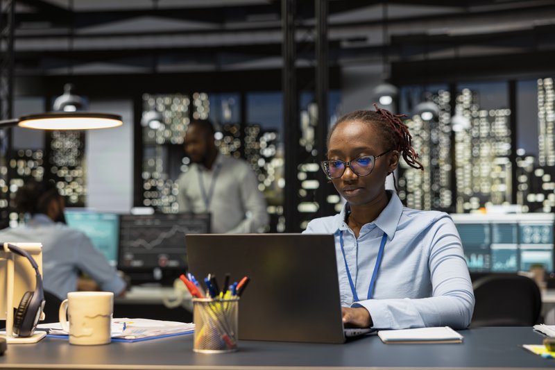 an office worker wokring on her laptop in an office