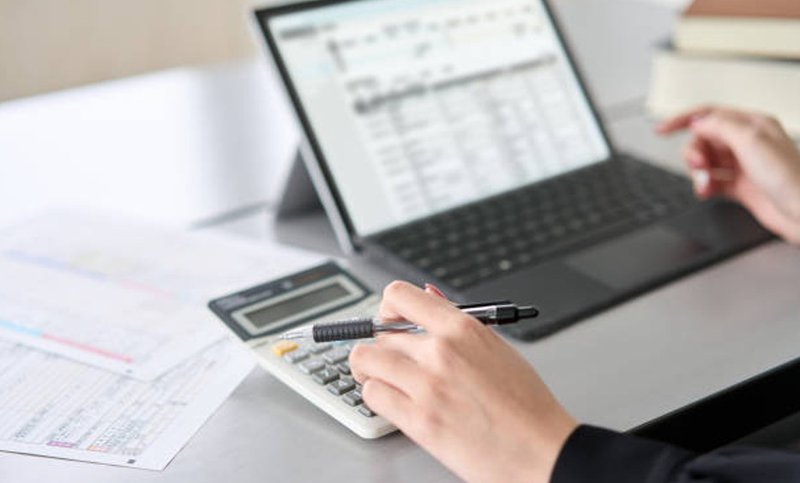 a laptop and calculator on a table. field operations