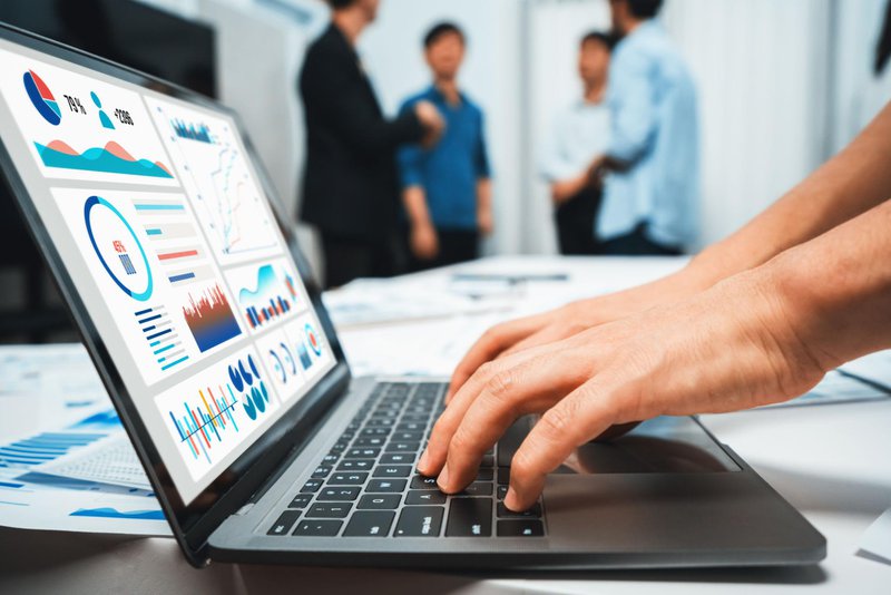 Business intelligence dashboard displaying financial KPIs, charts, and performance metrics on a laptop.