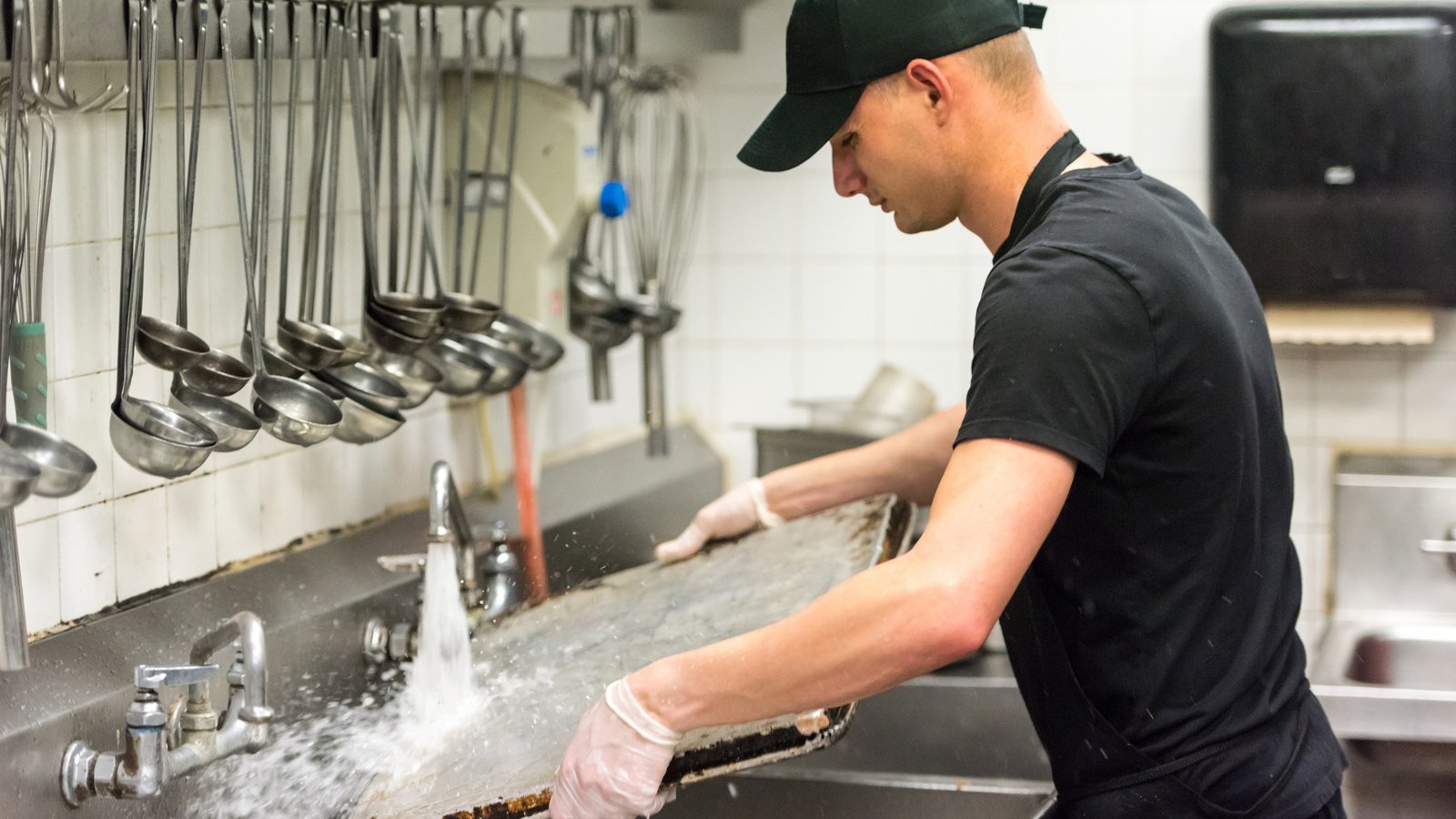 Commercial restaurant dishwashing station using hot water during kitchen operations