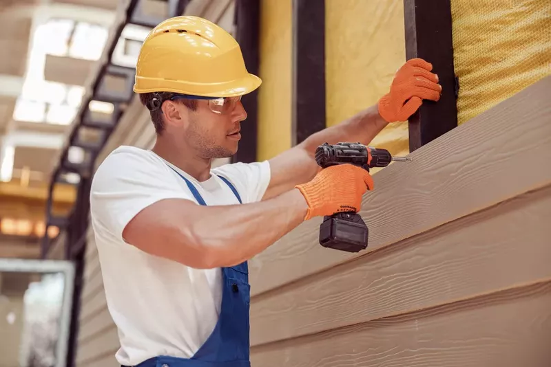 Experienced siding contractors installing new siding on a residential home