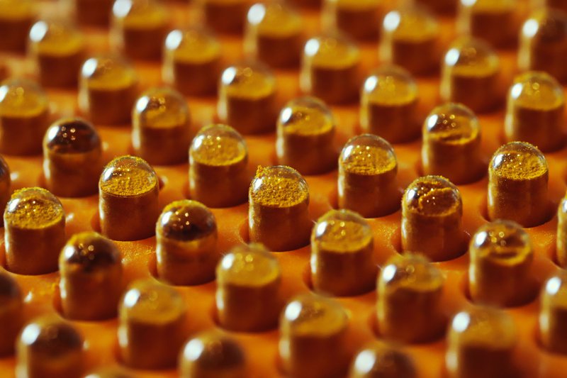 This photo shows powder blends encased in clear capsules
