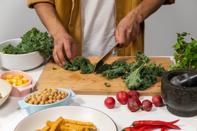 This photo features a person chopping kale
