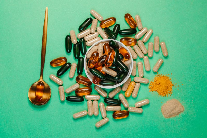 This photo shows supplements laid out on a green background