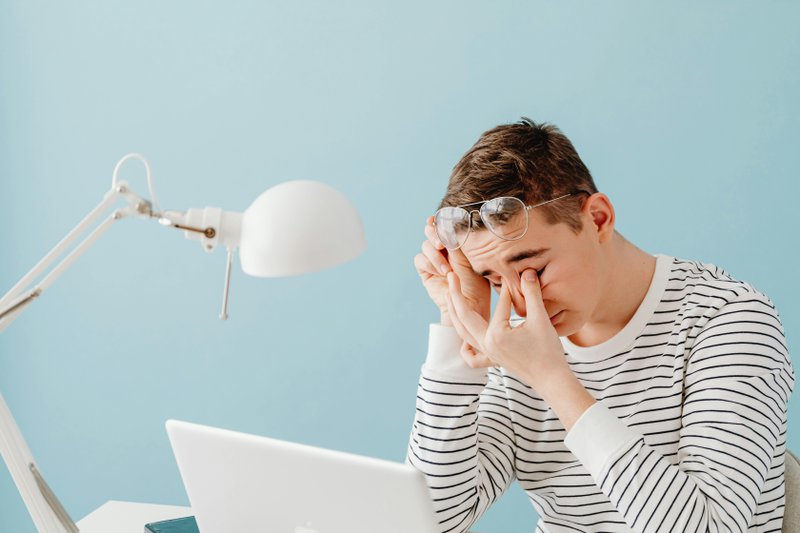 This photo shows a person dealing with eye strain