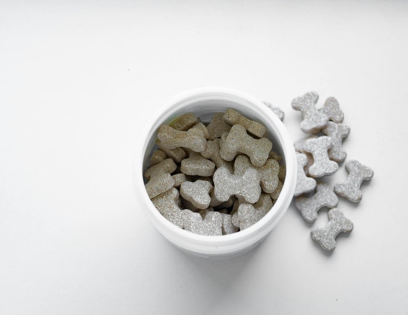 This photo features dog joint health supplement in a container