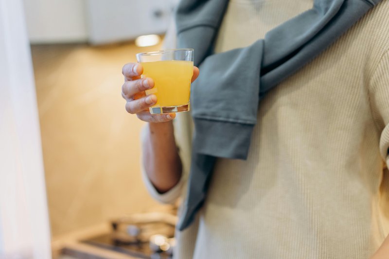This photo features a person drinking a natural gut health supplement