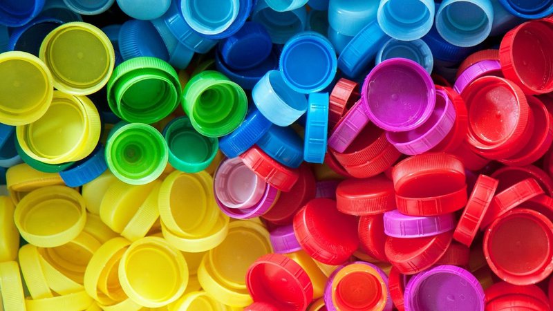 A collection of colorful plastic caps used for PET & HDPE Bottles for Beverages.