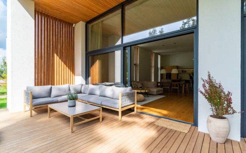 Modern covered deck featuring wood decking and vertical accent slats.
