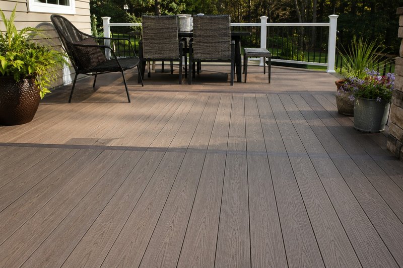 Modern backyard deck built with Trex composite decking featuring realistic wood-grain boards, hidden fasteners, and a low-maintenance outdoor living space.