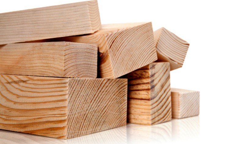 Close-up of Douglas fir beams stacked together to show wood grain and cut edges.