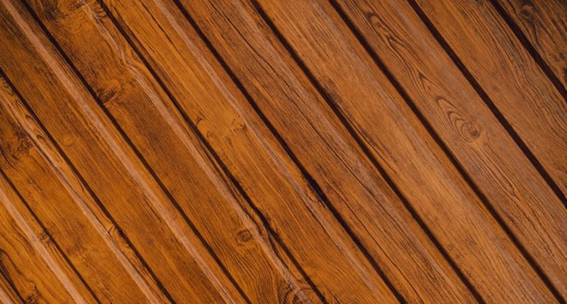 Close-up of timber decking boards with rich wood grain and a finished surface.