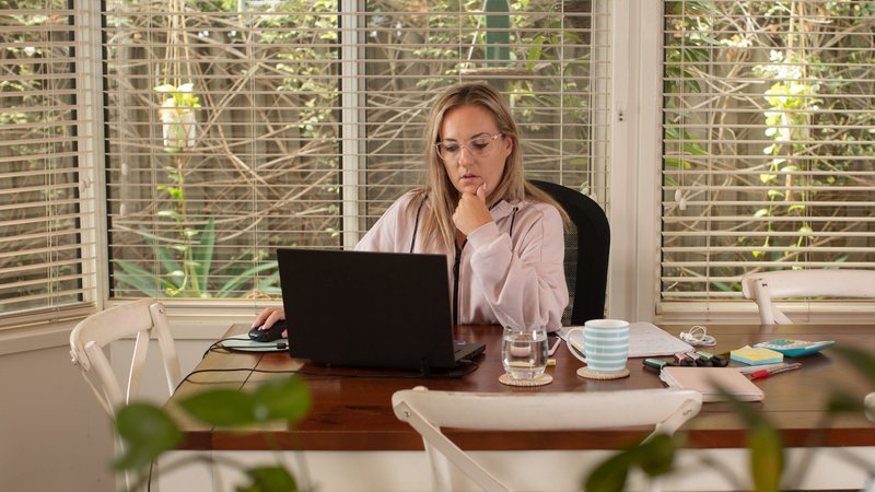 Volunteer HOA board member managing community responsibilities from home using online software