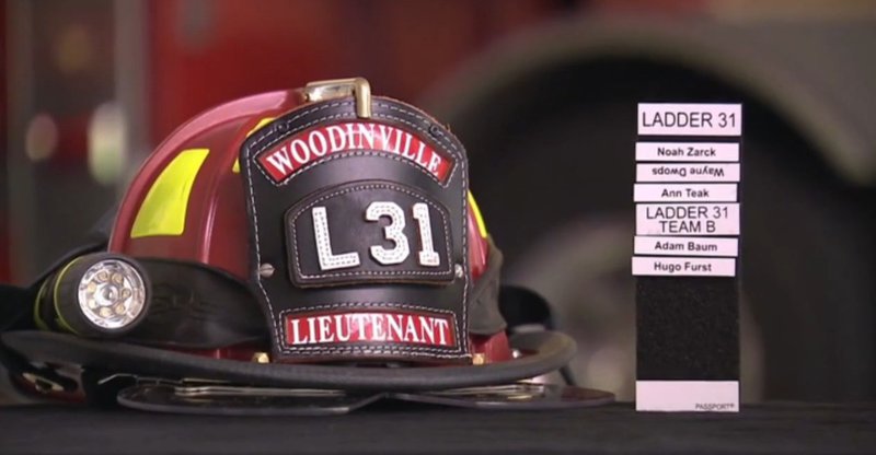 Passport accountability system tags beside a firefighter helmet.