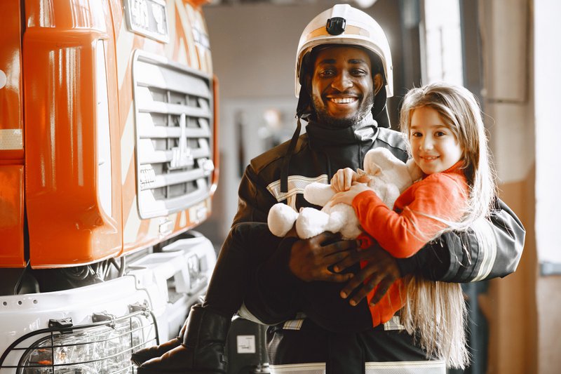 Fireman and a child in a fire department community relations event.