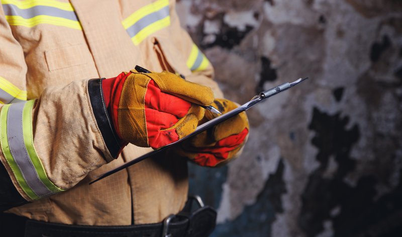 A firefighter goes through a checklist during a live fire training session.