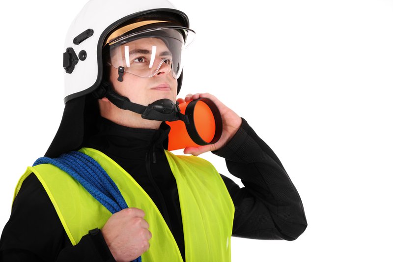 A young firefighter wearing a white helmet shield