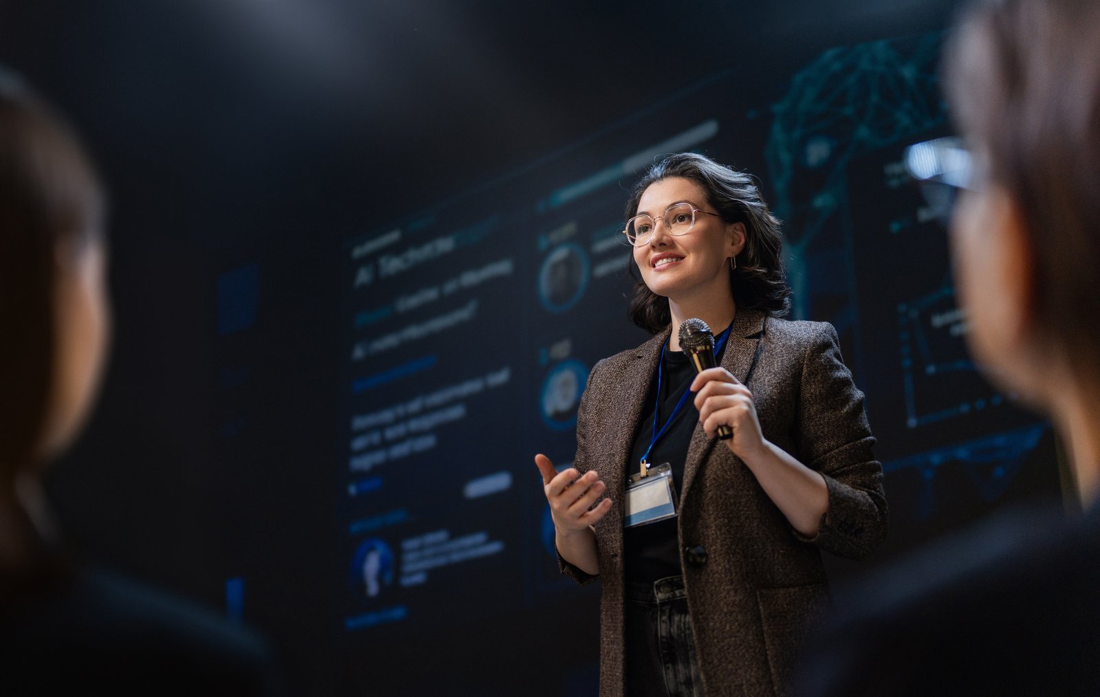 A woman at a convention, discussing structure options for software companies expanding internationally.