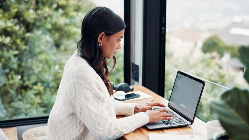 Payroll specialist processing employee payroll in an office.