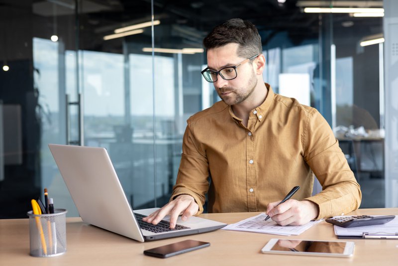 Commercial loan underwriter reviewing a company’s credit and financing profile