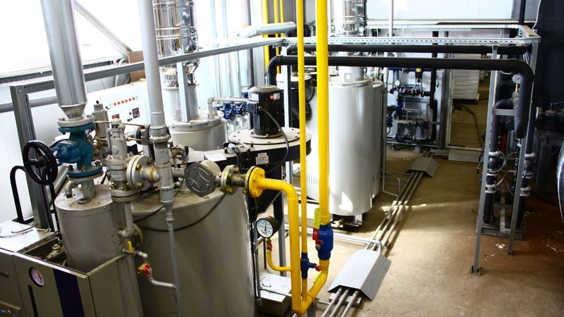 A mechanical equipment room with tanks and piping inspected for a Building Alteration Review.