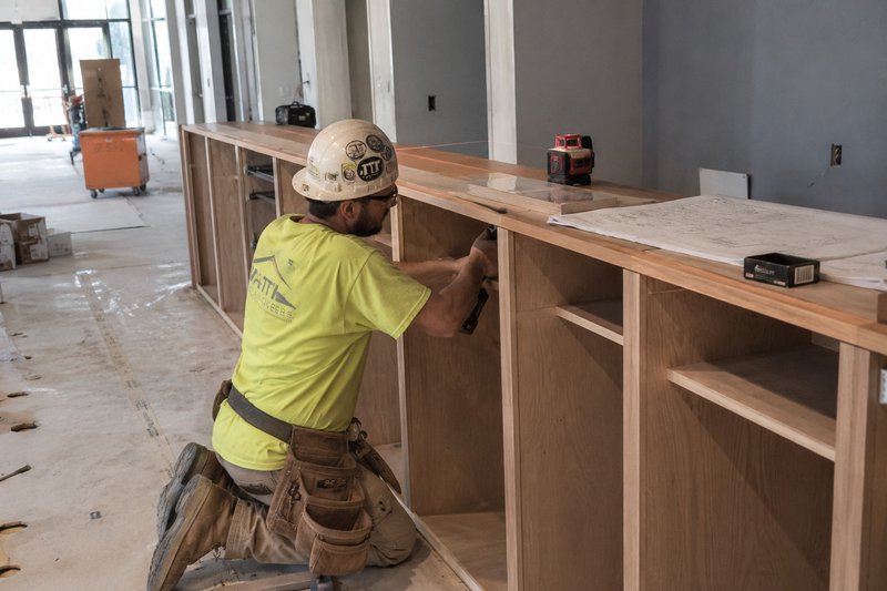 Commercial millwork installation and field coordination on a construction site