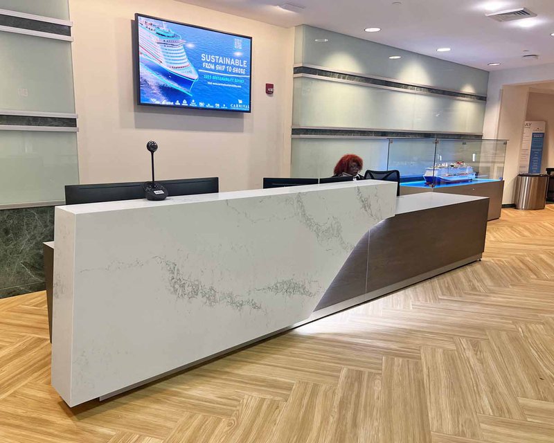 Commercial interior of a business lobby with a receptionist