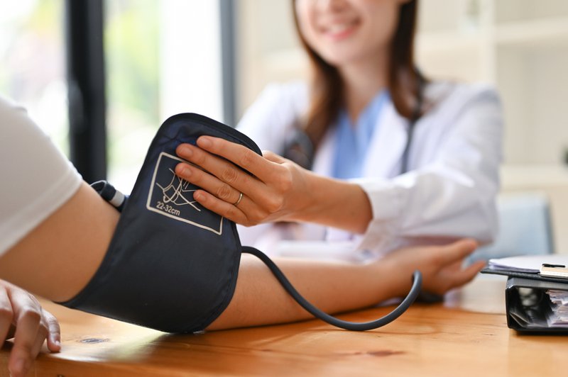 Doctor checking blood pressure of a patient