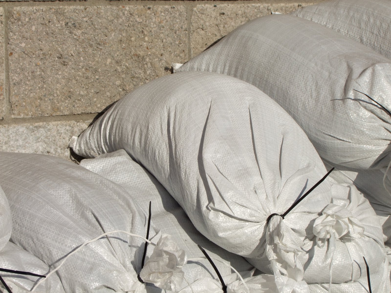 Stacked sandbags protecting a building from spring flooding, supported through a mutual aid agreement