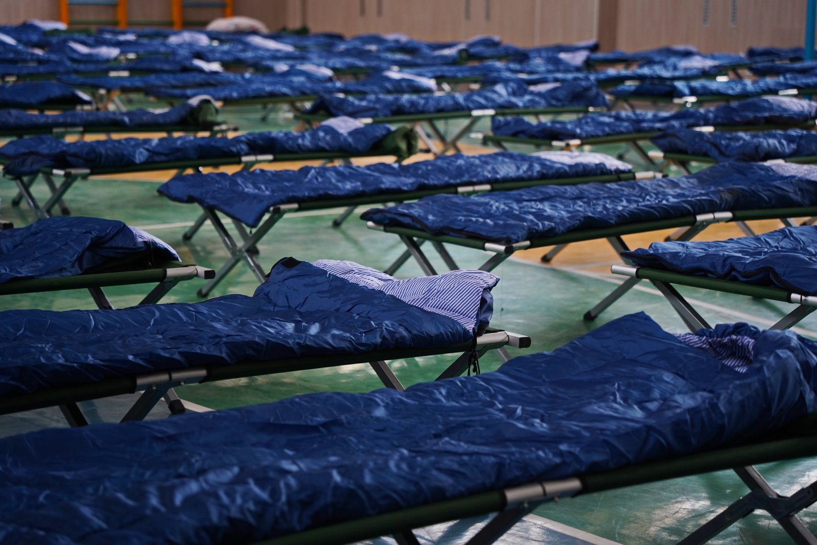 Emergency shelter cots in a gymnasium, the kind of resource a tabletop exercise tests before a real winter storm