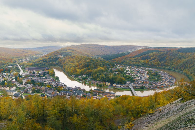 Méandre d'un fleuve en forme de fer à cheval autour d'un village dans les Ardennes françaises.