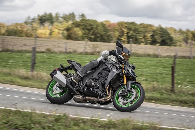 Kawasaki Z1100 SE sur une route de campagne, arbres en arrière-plan
