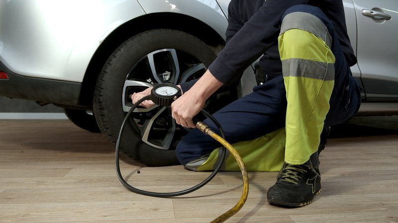 persoon checkt de bandenspanning van een band
